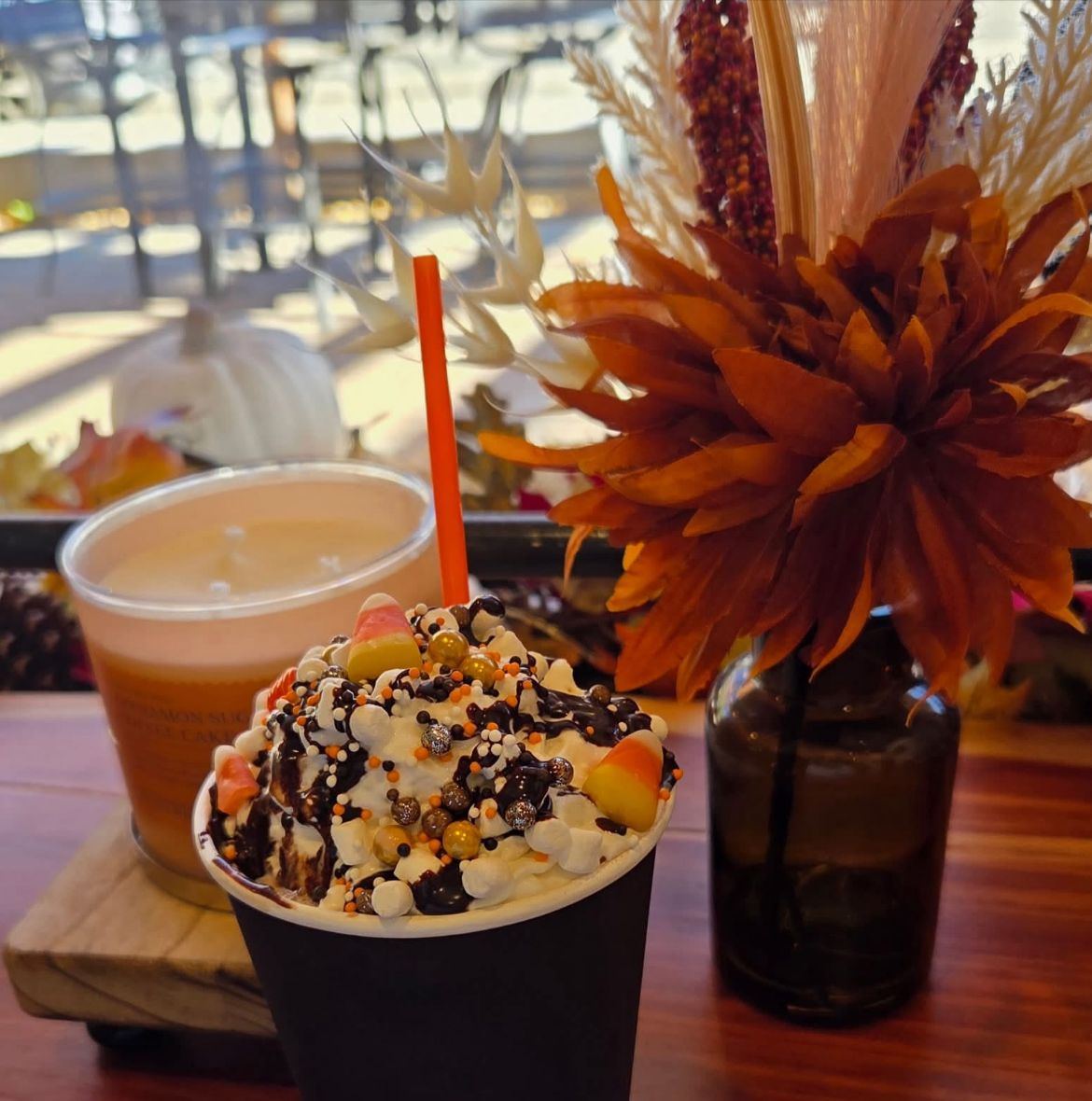 A loaded hot chocolate topped with candy and chocolate drizzle
